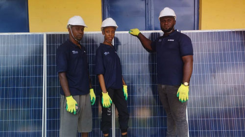 IEEE SIGHT volunteers in front of solar panels. IEEE SIGHT volunteers in front of solar panels.